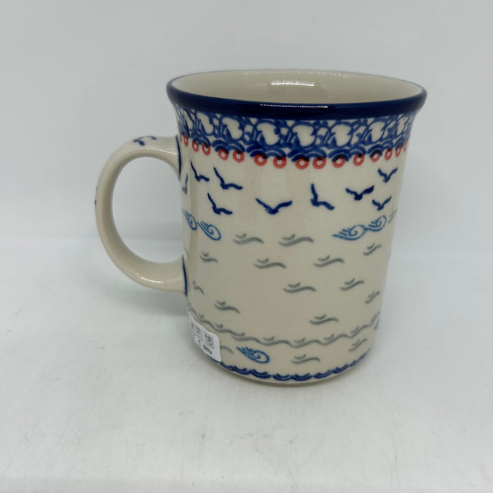 Back view of a large 16oz Ceramika Artystyczna Polish pottery B13 mug in the Unikat U5164 pattern, displaying the continuous hand-painted design of flying blue birds, waves, and the blue rim.