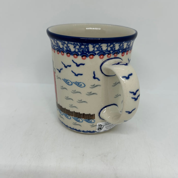 Close-up of the handle on a large 16oz Ceramika Artystyczna Polish pottery B13 mug in the Unikat U5164 pattern, showing straight sides, the blue rim, and the edge of the red lighthouse.
