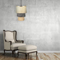 Enya 18"W Cream and Grey Fringe Pendant Light hanging above a beige armchair and ottoman against a textured gray wall.