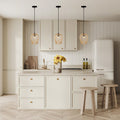 Lucinda 7.25"W Modern Gold Woven Metal Pendant Light hanging in modern kitchen with light wood cabinets, white refrigerator, and decorative elements.