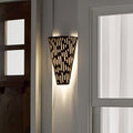 Noah Black Matte Metal Cone-Shaped Outdoor Wall Sconce on a wall with a door in the background