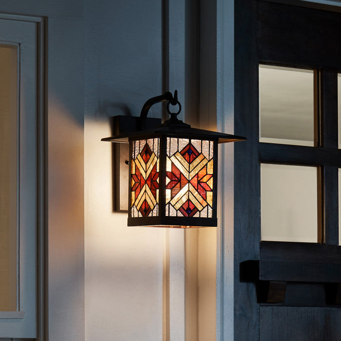 Red Stained Glass and Oil Rubbed Bronze 1-Light Outdoor Lantern Wall Sconce on a building exterior.