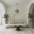 Rosalind 19.75"W Jute and Black Frame Pendant Light in a modern living room with a curved sofa, round table, and decorative plants.
