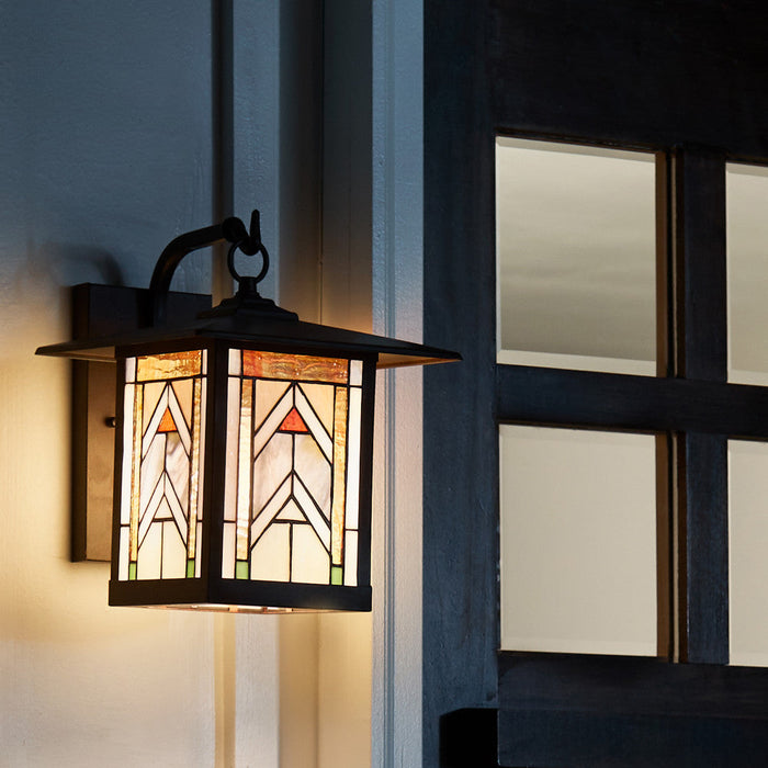 Terracotta Stained Glass and Oil Rubbed Bronze 1-Light Outdoor Lantern Wall Sconce on a building exterior.