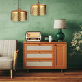 Veda 18"W Antique Brass Cutout Dome Pendant Lightin a vintage-style room with wooden cabinet, radio against a green wall.